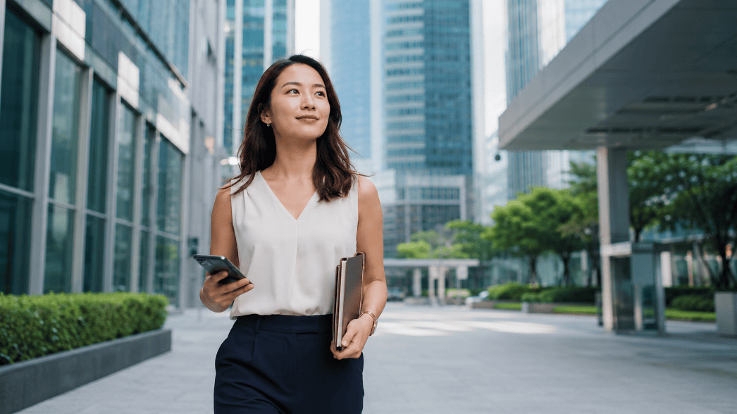 Singaporean professional navigating a life transition with confidence in a modern city setting
