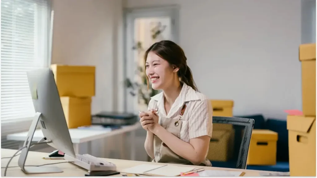 Professional smiling at her desk while navigating a career transition