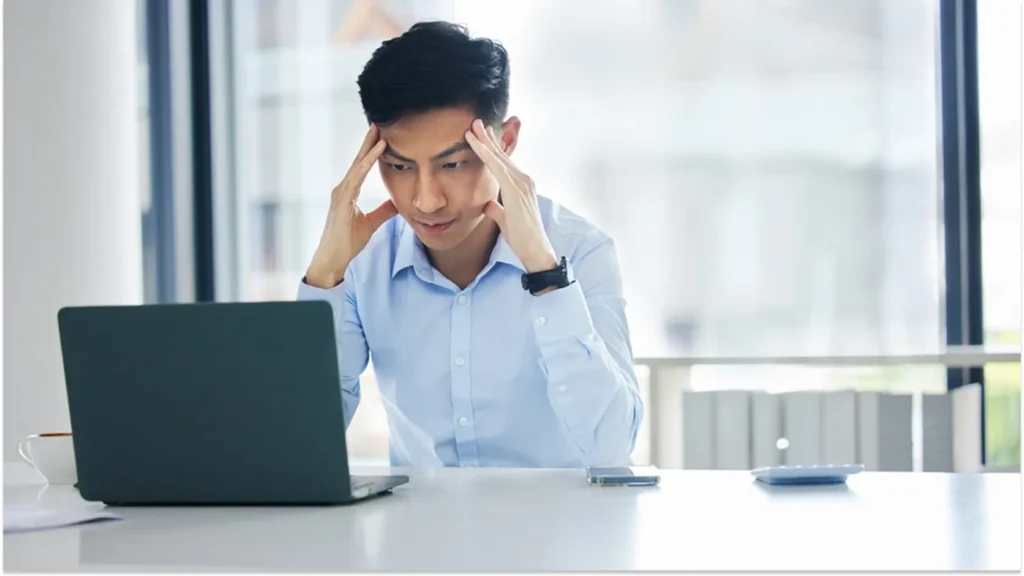 Frustrated young professional feeling stuck and unmotivated at work